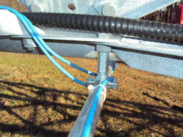 Detail of mounting rigid conduit to Bergey Excel SSV tower for an anemometer boom
