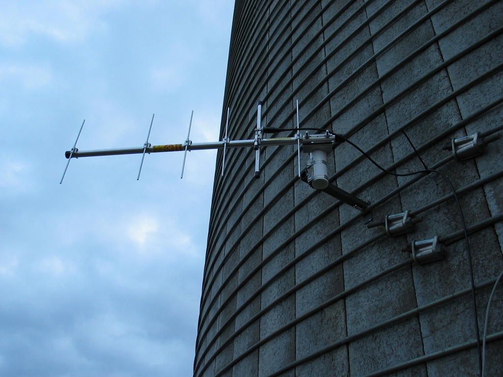 Example bracket for mounting an antenna or anemometer to a silo band