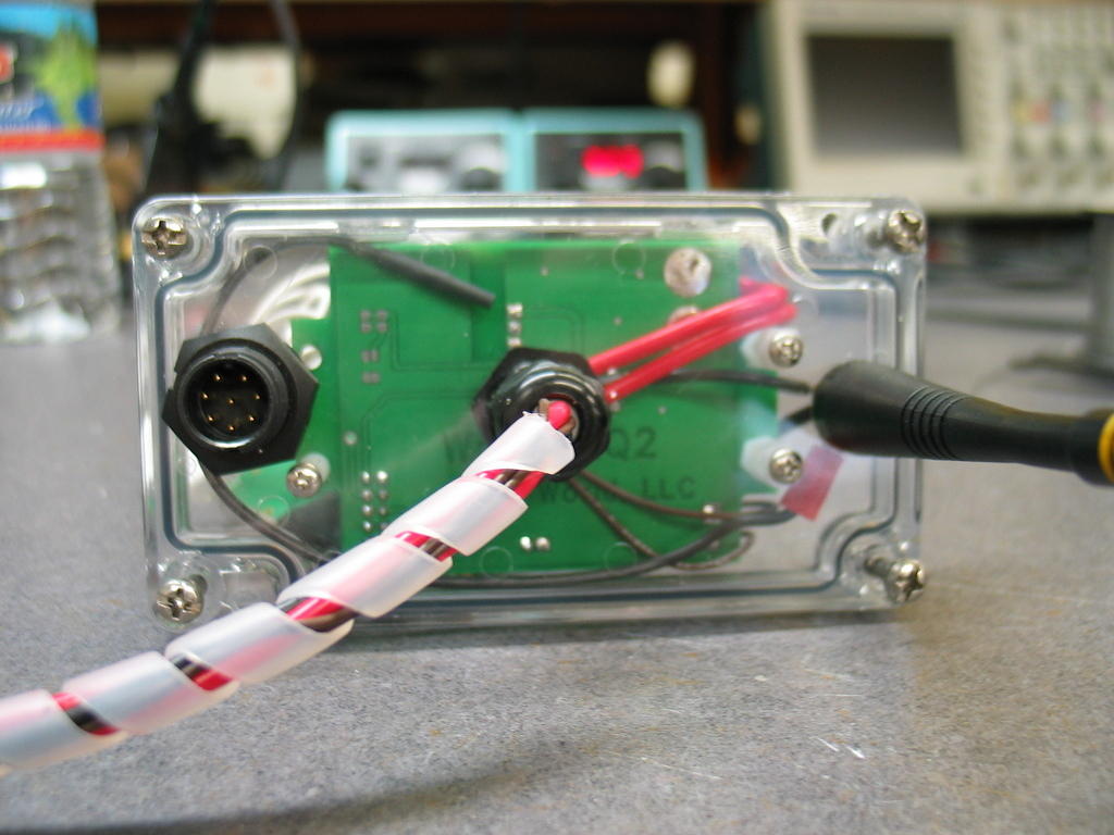 Bottom cover of the WrenDAQ2. The weatherproof connector on the left is for connecting the external temperature sensor, anemometer, and RPM sensor. The middle feedthru is for DC, AC (to pickup frequency), and ground. The antenna on the left is for the ...