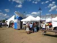 APRS World's s-kid with Chinook Turbines' and Midnite Solar's booths