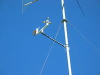Mounting arm with anemometer, wind vane, and tee installed