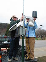 Clare Jarvis and Alyssa Anderson install the sensor mounting arm